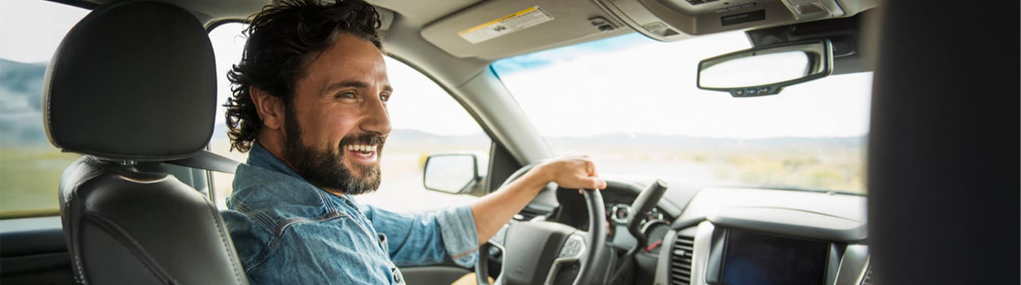 The image shows a very smiling driver